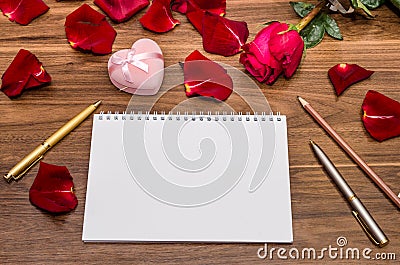 Gift rose and box and blank notepad Stock Photo