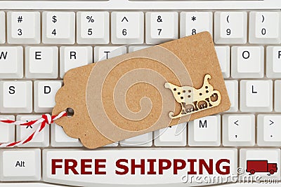 A gift tag on a keyboard with text Free Shipping Stock Photo