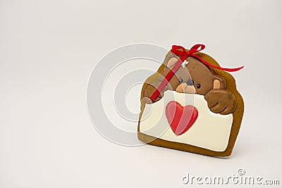 Gift for Valentine`s Day. Original gingerbread, a bear with a heart Stock Photo