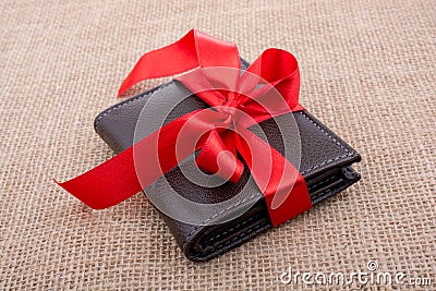 Gift wallet wrapped with red ribbon Stock Photo
