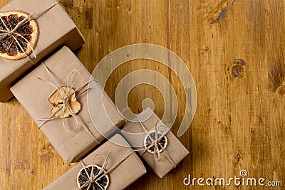 Gifts decorated with dry citrus on wooden background top view Stock Photo