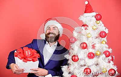 Gifts shop. Christmas party. Man bearded hipster formal suit christmas tree hold gift box. Christmas gifts. Winter Stock Photo