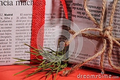 Gifts wrapped in old newspaper on red background Editorial Stock Photo