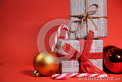 Gifts wrapped in old newspaper on red background Editorial Stock Photo