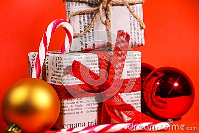 Gifts wrapped in old newspaper on red background Editorial Stock Photo