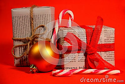 Gifts wrapped in old newspaper on red background Stock Photo