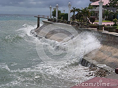 Waves crashing on the seawall Stock Photo