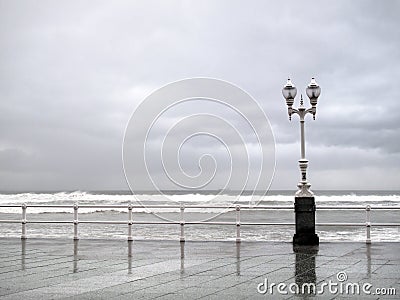 Gijon promenade with lamppost in rainy day Stock Photo