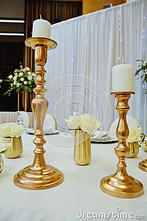 Gilded candlestick on a festive wedding table. Elegance wedding decor Stock Photo