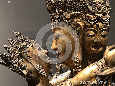 The gilded four-armed form of Avalokiteshvara Buddha statue Editorial Stock Photo