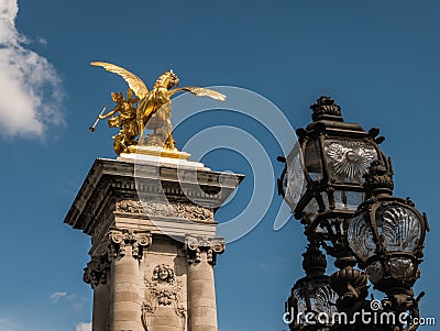 Gilded sculpture and iron lamps on Pont Alexandre III, Paris Editorial Stock Photo