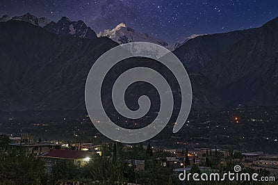 Gilgit City Center View and Saddar Bazaar at night with the sky furrowed by star trails Stock Photo