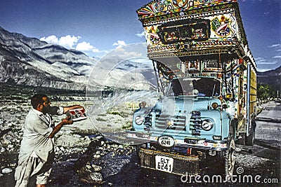 GILGIT, PAKISTAN - JULY 1, 1987: man cleans his overland truck with water from a creek in Gilgit, Pakistan. People suffer in that Editorial Stock Photo