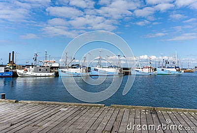 Beautiful thatched roof house with a vegetable garden under a blue sky with white cumulus clouds Editorial Stock Photo