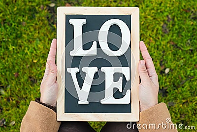 Gilr hands holding a blackboard Stock Photo