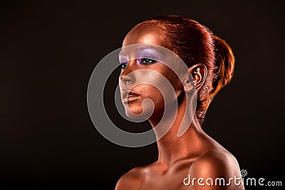 Gilt. Golden Woman's Face Closeup. Futuristic Gilded Make-up. Painted Skin bronze. Stock Photo