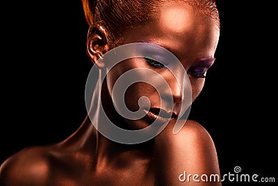 Gilt. Golden Woman's Face Closeup. Futuristic Gilded Make-up. Painted Skin bronze. Stock Photo