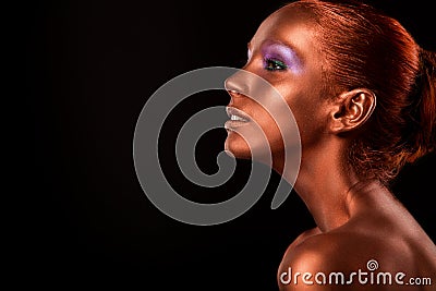 Gilt. Golden Woman's Face Closeup. Futuristic Gilded Make-up. Painted Skin bronze. Stock Photo