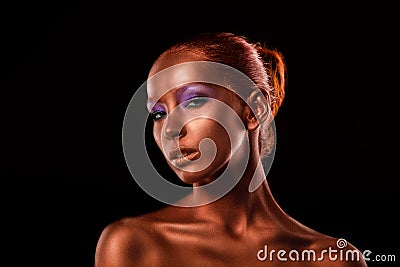 Gilt. Golden Woman's Face Closeup. Futuristic Gilded Make-up. Painted Skin bronze. Stock Photo