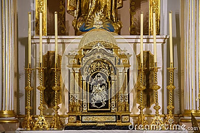 A gilt reliquary lavishly decorated in gold, inside a Catholic church Stock Photo