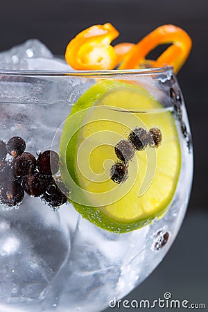 Gin tonic cocktail macro closeup with juniper berries Stock Photo