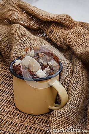 Ginger and Caramel warm pudding with roasted coconut sprinkle Stock Photo