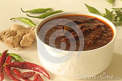 Ginger curry is a dark brown sweet-sour and spicy Keralite curry made of ginger, tamarind, green chillies and jaggery Stock Photo
