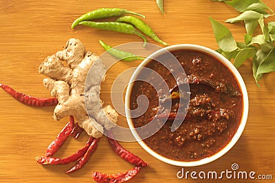 Ginger curry is a dark brown sweet-sour and spicy Keralite curry made of ginger, tamarind, green chillies and jaggery Stock Photo