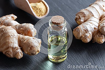 Ginger essential oil with fresh ginger root and powder Stock Photo