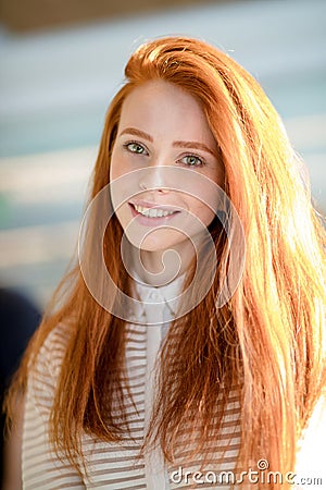 Ginger female with long straight shiny hair and natural make-up smiling Stock Photo