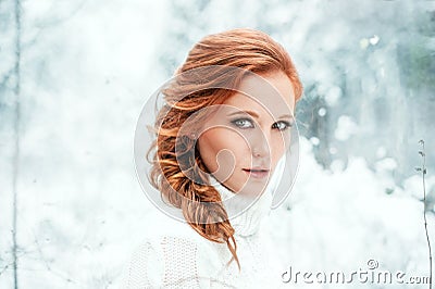 Ginger happy female in white sweater in winter forest. Snow december in park. Portrait. Christmas cute time. Stock Photo
