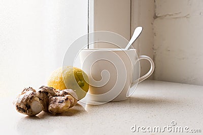 Ginger, lemon and white cup next to window Stock Photo