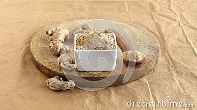 Ginger Powder in a Bowl and Raw and Dried Ginger on a Wooden Table Stock Photo