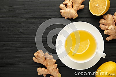 Ginger tea with lemon in a white cup on blakc wooden background Stock Photo