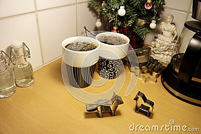 Two animal shaped gingerbread cookie cutters stands up on a kitchen countertop Stock Photo