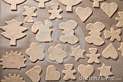 Gingerbread cookie in different shapes on light baking paper like background Stock Photo