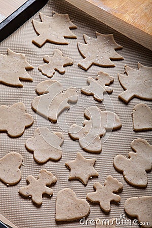 Gingerbread cookie in different shapes on light baking paper like background Stock Photo