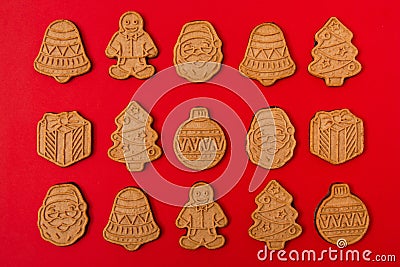 Gingerbread cookie pattern on red background. Traditional winter biscuit cookies with ornament. Christmas or New Year design Stock Photo