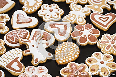 Gingerbread cookies in the form of a rabbit, flowers, hearts, grandmothers and Easter eggs, covered with white and chocolate icing Stock Photo