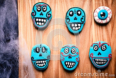 Gingerbread cookies for Halloween party. Blue painted skulls. Stock Photo