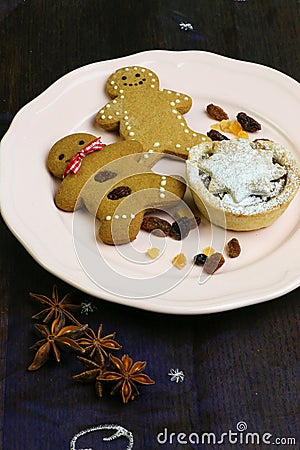 Gingerbread cookies and mince pie on ceramic plate Stock Photo