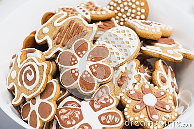 Gingerbread cookies in the shape of an Easter bunny, butterflies and flowers, covered with white and chocolate icing-sugar Stock Photo