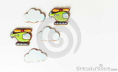 Gingerbread cookies in the shape of military helicopters flying in the clouds. Army or Men`s day. Flat lay on white Stock Photo