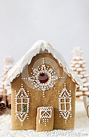 Gingerbread house and gingerbread tree on a light background. Stock Photo