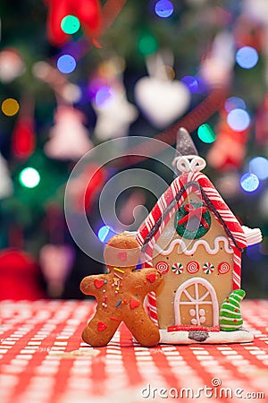 Gingerbread man in front of his candy ginger house Stock Photo