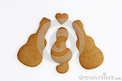 Gingerbreads in a shape of guitar, treble clef and heart on white background Stock Photo