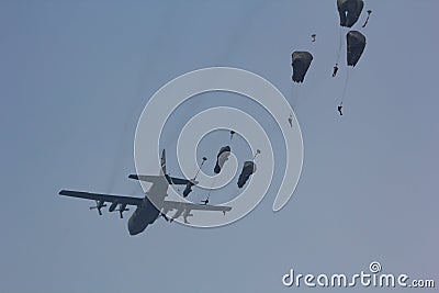 Ginkelse heide sep 20 2014: Market Garden memorial paratroopers jumping from an aircraft. Editorial Stock Photo