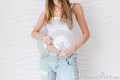 The girl adjusts her shirt. Slim figure, press, belly Stock Photo