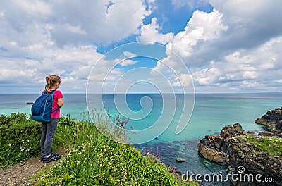 Girl admiring the Cornish coast Stock Photo