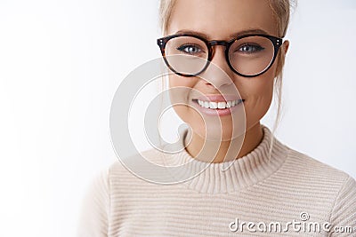 Girl adores new glasses picked in optician store standing happy and delighted against white background smiling satisfied Stock Photo